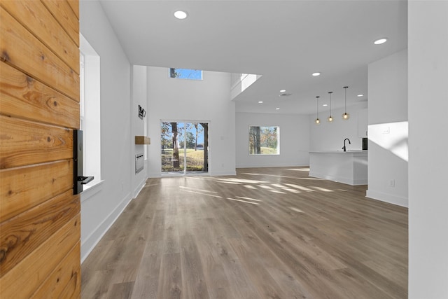 unfurnished living room featuring sink and hardwood / wood-style floors