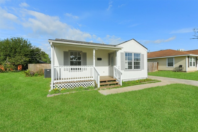 ranch-style home with covered porch and a front yard