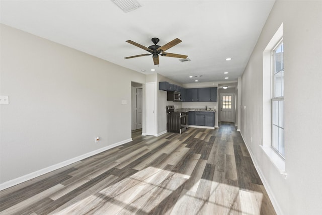 unfurnished living room featuring dark hardwood / wood-style flooring and sink