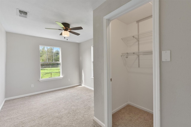 unfurnished bedroom with carpet flooring, ceiling fan, and a closet