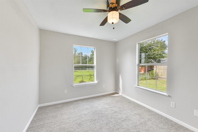 empty room featuring ceiling fan and carpet