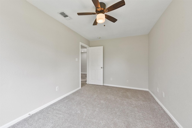 empty room with ceiling fan and carpet flooring