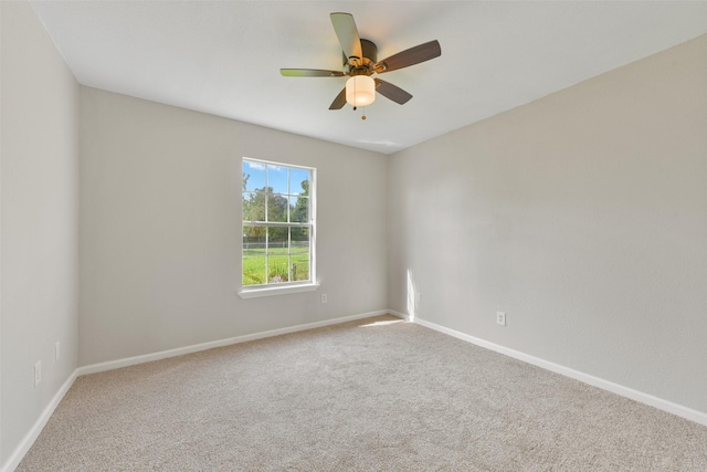 unfurnished room featuring ceiling fan and carpet floors