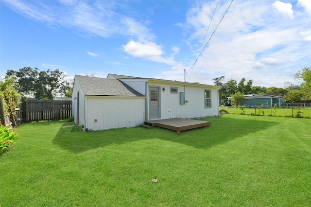 rear view of house with a yard and a deck