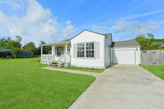 view of front of home with a porch, a front yard, and a garage