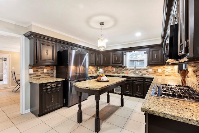 kitchen featuring stainless steel appliances, backsplash, and hanging light fixtures