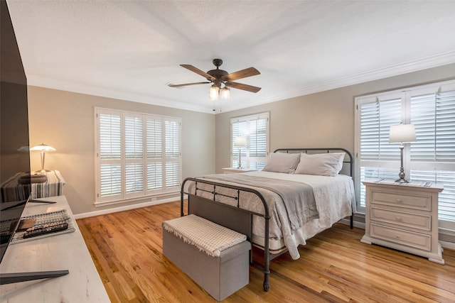 bedroom featuring light wood-type flooring, ceiling fan, and crown molding