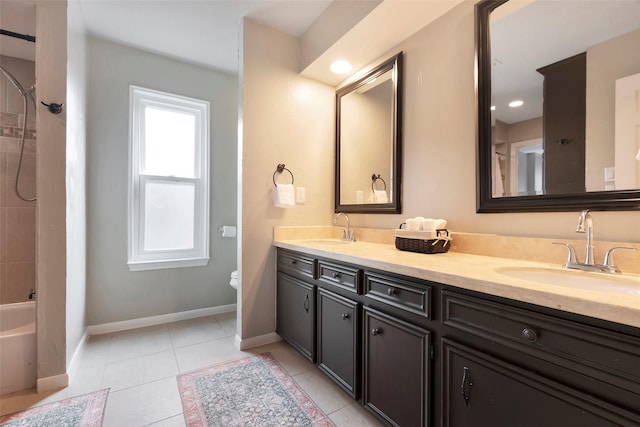 bathroom with tiled shower / bath combo, tile patterned floors, and vanity