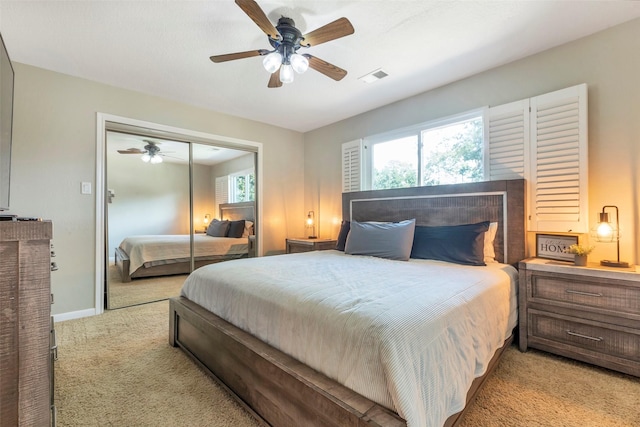 carpeted bedroom featuring a closet and ceiling fan