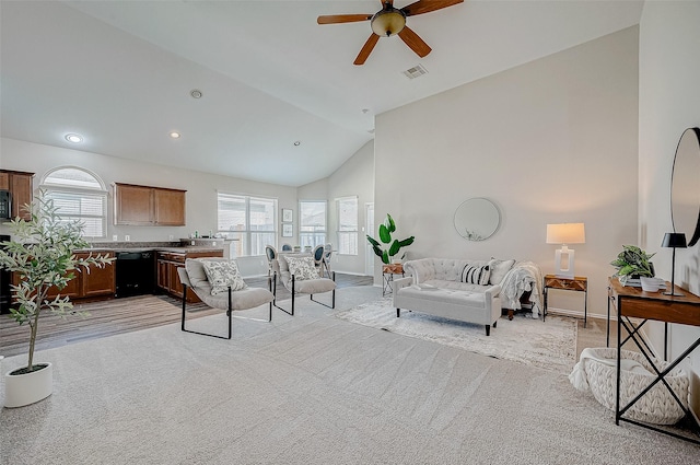 carpeted living room with ceiling fan and lofted ceiling