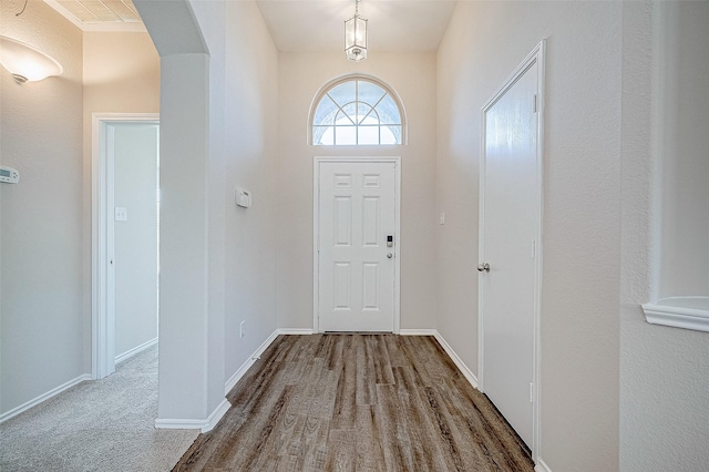 carpeted foyer with a high ceiling