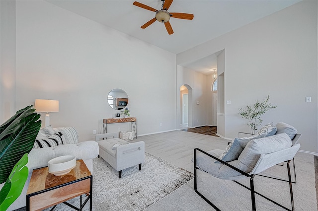 living room featuring light colored carpet and ceiling fan