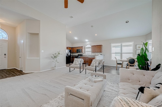 living room featuring high vaulted ceiling, ceiling fan, and light hardwood / wood-style flooring