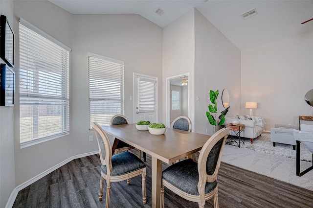 dining space with lofted ceiling, ceiling fan, and dark hardwood / wood-style floors