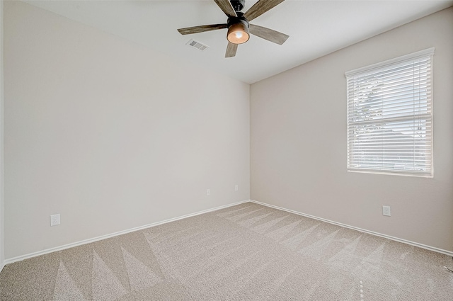 carpeted spare room with ceiling fan