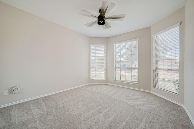 spare room with carpet floors and ceiling fan