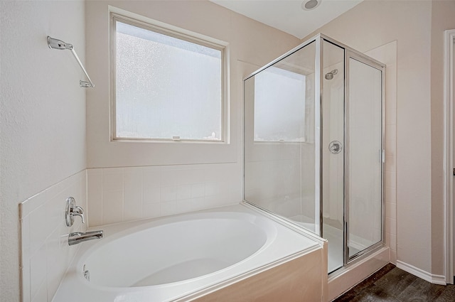 bathroom with plus walk in shower and hardwood / wood-style floors