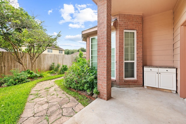 view of exterior entry featuring a patio area