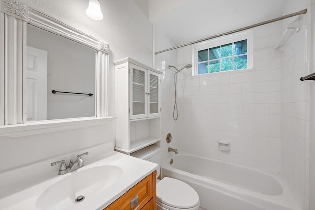 full bathroom with toilet, vanity, and tiled shower / bath