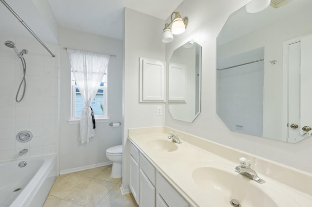 full bathroom featuring vanity, tiled shower / bath, tile patterned floors, and toilet