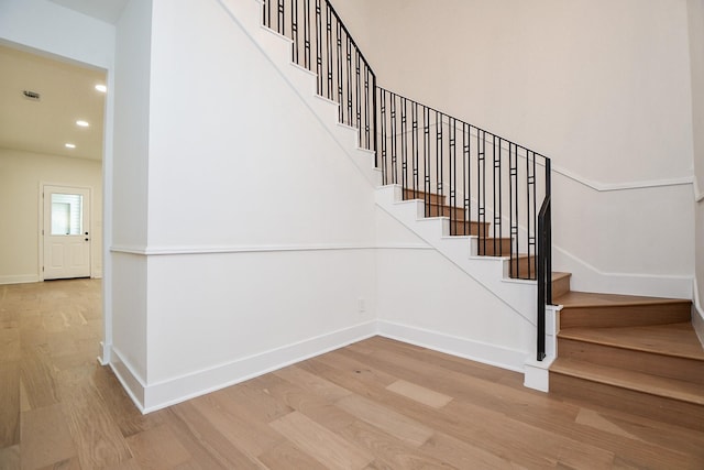 stairs featuring hardwood / wood-style flooring