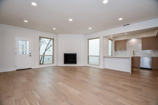 unfurnished living room featuring light hardwood / wood-style flooring