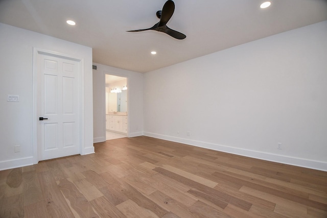 spare room with light wood-type flooring and ceiling fan