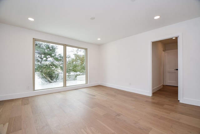 unfurnished room with light wood-type flooring