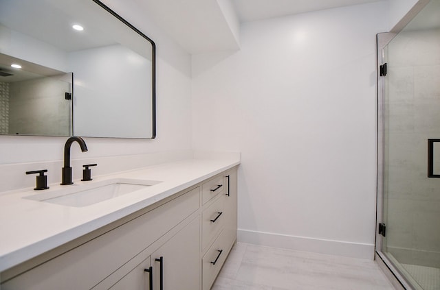 bathroom with an enclosed shower and vanity