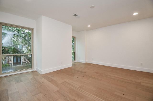 unfurnished room featuring plenty of natural light and light hardwood / wood-style flooring