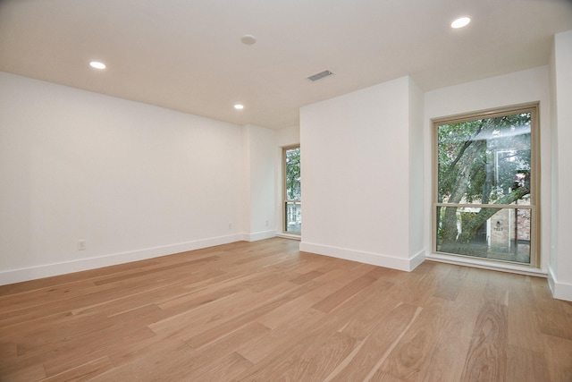 empty room with light hardwood / wood-style flooring