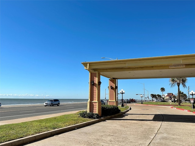 view of street with a beach view and a water view