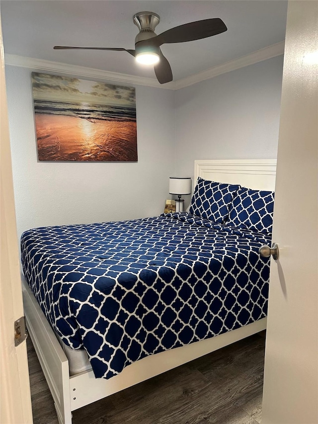 bedroom with ornamental molding, ceiling fan, and wood-type flooring