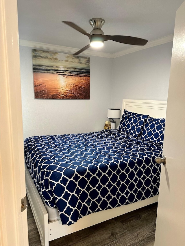 bedroom with ceiling fan, crown molding, and wood-type flooring