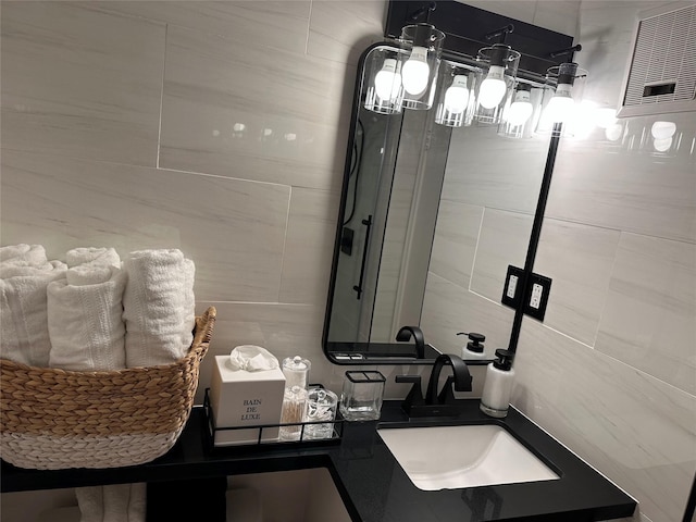 bathroom with sink and tile walls