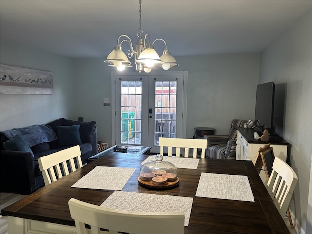 dining area featuring french doors, dark hardwood / wood-style flooring, and a chandelier