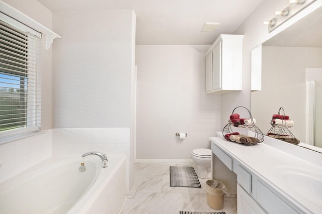 bathroom featuring toilet, vanity, and a bath