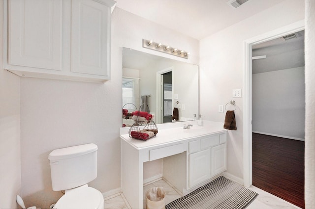 bathroom featuring toilet and vanity