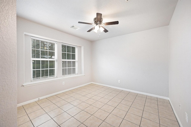 unfurnished room with ceiling fan and light tile patterned floors