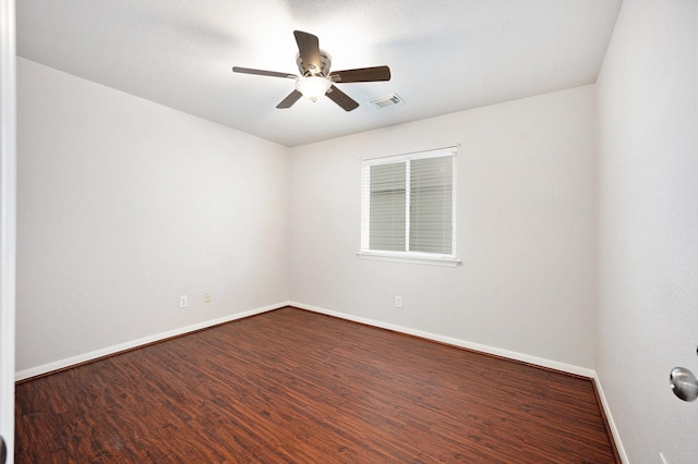 spare room featuring ceiling fan and dark hardwood / wood-style floors