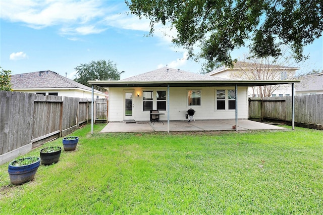 back of house featuring a patio area and a lawn