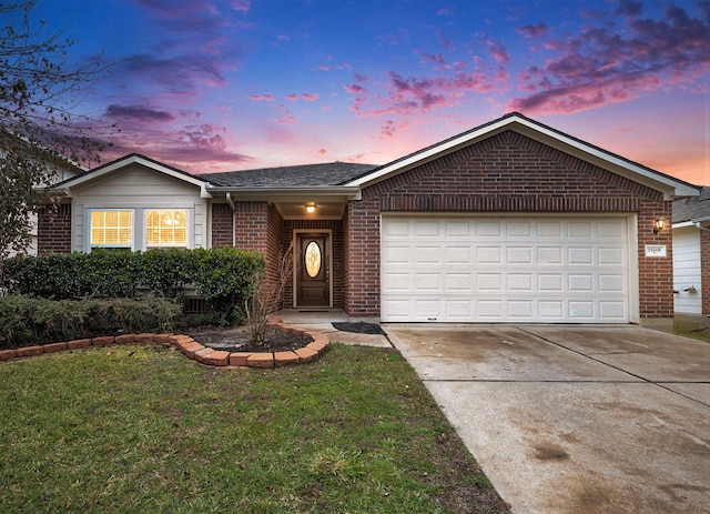 single story home featuring a yard and a garage