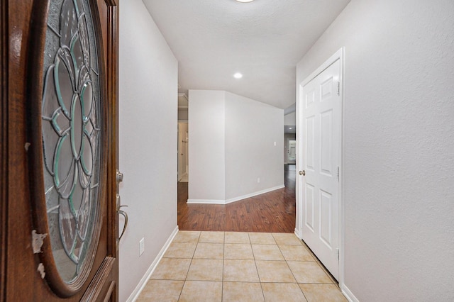 corridor with light tile patterned flooring