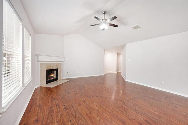 unfurnished living room featuring ceiling fan, dark hardwood / wood-style flooring, vaulted ceiling, and a fireplace