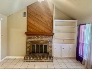 unfurnished living room with a brick fireplace, lofted ceiling, built in shelves, and light tile patterned floors