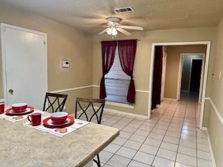 tiled dining area with ceiling fan