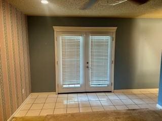 doorway with ceiling fan, french doors, and light tile patterned flooring