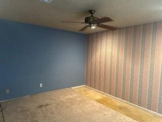 spare room featuring ceiling fan and carpet flooring