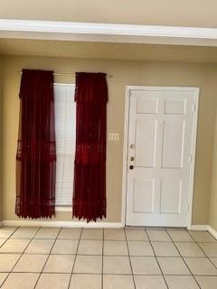 entryway with light tile patterned flooring