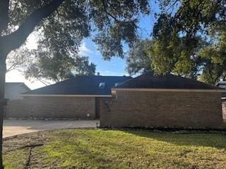 view of property exterior featuring a lawn